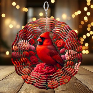 May include: A red cardinal bird wind chime with a metal design. The cardinal is perched on a branch of red flowers. The wind chime is made of metal and has a silver hanger.