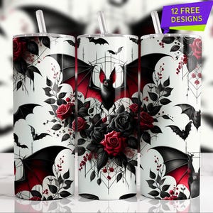 May include: White tumbler with a bat and floral design. The design features a black bat with red accents, surrounded by red and black roses, and bat silhouettes. The tumbler includes a straw and the text "12 FREE DESIGNS".