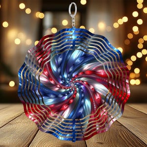 May include: A red, white, and blue metal wind spinner with a spiral design. The spinner is suspended from a silver hook.