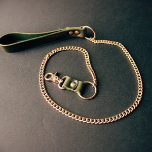Green leather leash with gold hardware.