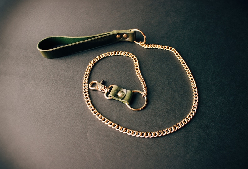Green leather leash with gold hardware.