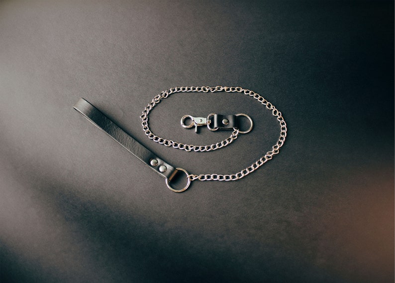 Black leather leash with gold hardware.