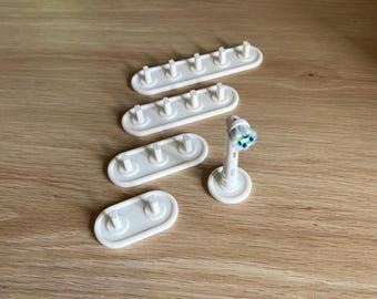 Soporte para cabezal de cepillo de dientes Oral-B, varios colores disponibles.