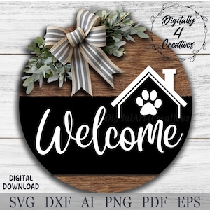 May include: A round wooden sign with a black and white welcome sign with a paw print in a house shape. The sign is decorated with a gray and white striped bow and greenery.