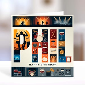 May include: A square greeting card featuring the name PHIL in large letters filled with illustrations of drum kits, cymbals, drumsticks, and stage equipment. The text HAPPY BIRTHDAY appears below the name, with concert stage scenes at the top and bottom.