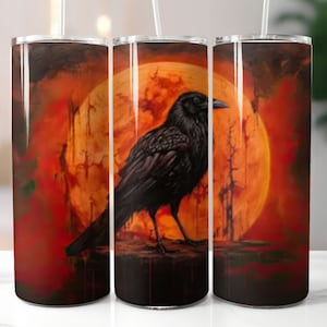May include: Three stainless steel tumblers with a black raven silhouette perched on a red and orange sunset moon. The raven has a black body and a long, pointed beak.