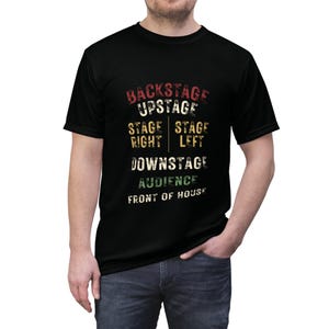 May include: Black t-shirt with a vintage-style graphic that reads "Backstage Upstage Stage Right Stage Left Downstage Audience Front of House".