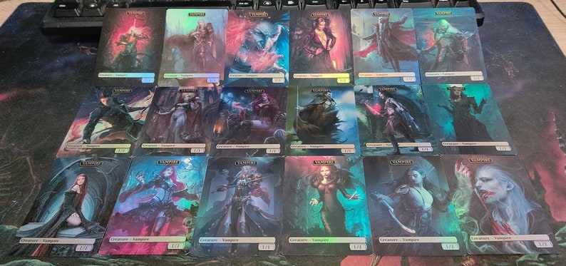 May include: A collection of 18 trading cards featuring various vampire characters. The cards are holographic and have a dark, gothic aesthetic. Each card features a different vampire with unique artwork and details.