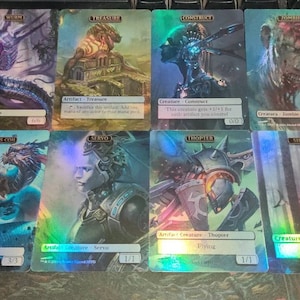 May include: A set of ten Magic: The Gathering cards featuring various creatures and artifacts. The cards are holographic and have a rainbow sheen. The cards include a blue and white creature called "Morm", a gold artifact called "Treasure", a blue and white creature called "Construct", a red and white creature called "Zombie", a blue and white creature called "Magma", a blue and white creature called "Servo", a blue and white creature called "Thopter", and a blue and white creature called "Shark".