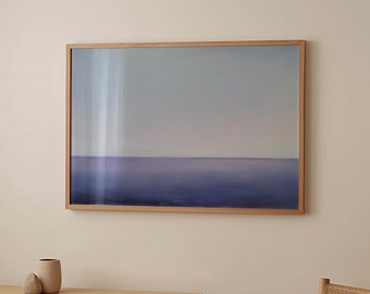 May include: A light wood console table with a light wood chair in front of it. A framed print of a purple and blue seascape hangs on the wall behind the table.