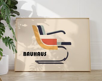 May include: A beige poster with a black and white illustration of a chair. The chair is yellow, red, and blue. The text "BAUHAUS" is printed in black below the chair.