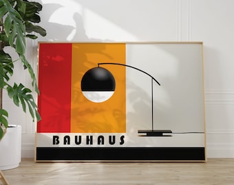 May include: A framed poster with a black and white geometric design and the word "BAUHHAUS" in black text. The poster has a red, yellow, and orange background.