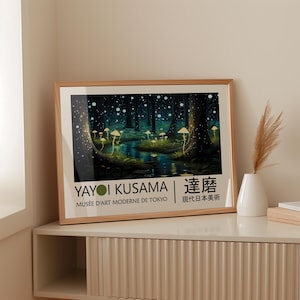 May include: A framed poster with a dark green forest scene with glowing white dots and mushrooms. The poster has the text "Yayoi Kusama | Kusama | Mus&eacute;e d'Art Moderne de Tokyo | 現代日本美術" in black and white.