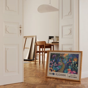 May include: A framed print of a colourful abstract painting by Yayoi Kusama. The painting features a path winding through a field of flowers and mushrooms. The text "Japan 1972" and "現代日本美術" is printed in the bottom right corner of the print.