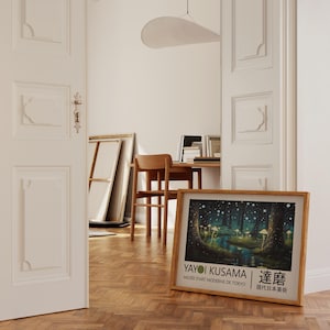 May include: A framed poster with a colorful illustration of a forest with glowing mushrooms. The poster is titled "Yayoi Kusama" and features the text "Musee d'Art Moderne de Tokyo" and "草間" in Japanese.