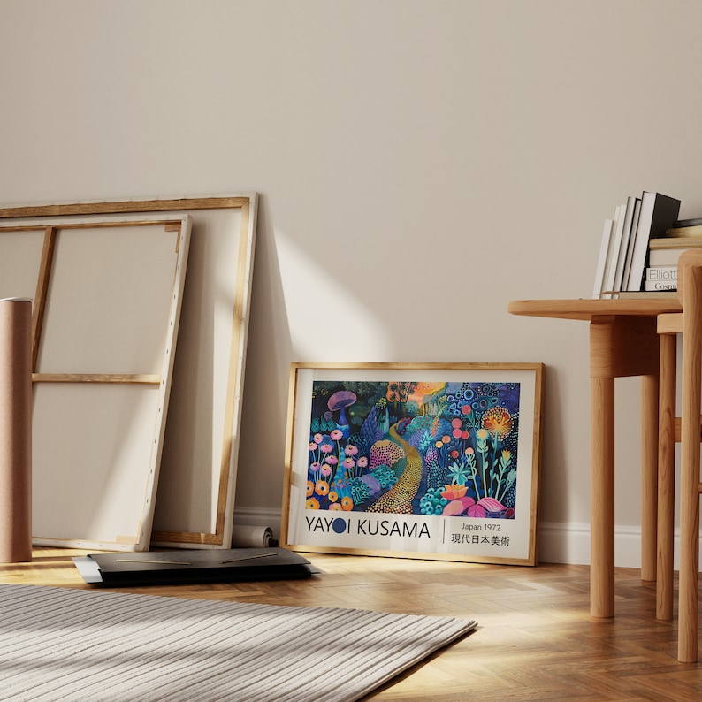 May include: A framed poster featuring a colourful illustration of a forest path with flowers and mushrooms. The poster is by Yayoi Kusama and says "Japan 1972,  現代日本美術展".