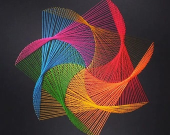 May include: A colourful string art piece with a starburst design. The art is made with different coloured threads, including red, orange, yellow, green, blue, and purple.