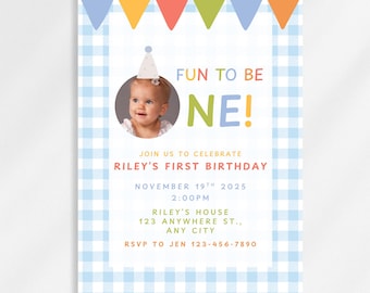 May include: A light blue gingham patterned invitation with colorful pennants across the top. The invitation features a photo of a baby wearing a party hat, with the words "FUN TO BE ONE!" and details for Riley's first birthday.