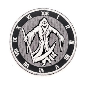 May include: Black and white embroidered patch of a hooded figure holding a scythe, with Roman numerals around the edge, representing a clock face.