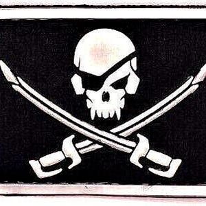 May include: A black and white skull and crossbones design on a silver metal belt buckle. The skull has an eyepatch and the crossbones are made of swords.