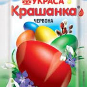 May include: A packet of red food coloring for dyeing Easter eggs. The packet features a rainbow, a flower, and a red egg. The text on the packet reads "UKRASA Krasyanka Chervona" and "Barvnyk dlya yats", which translates to "Dye for eggs".