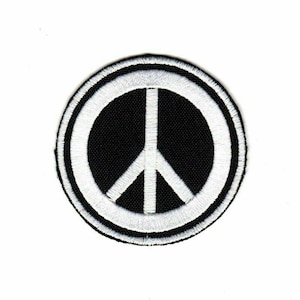 May include: A white peace sign embroidered on a black circular patch.