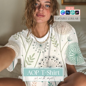 May include: White AOP T-shirt mockup featuring a floral design with dandelions and leaves in shades of green and teal. The shirt has a round neckline and short sleeves. The text "AOP T-Shirt mockup" is displayed on the bottom of the shirt.