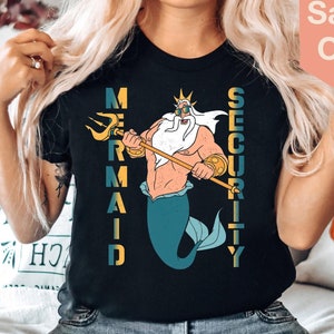May include: A black t-shirt with a graphic of King Triton from The Little Mermaid. The text "Mermaid Security" is printed vertically on the shirt.