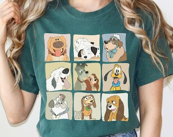May include: A teal green t-shirt with a vintage-style graphic of various Disney dog characters in squares. The characters include Lady, Tramp,  Pluto,  and  Dalmatian puppies.