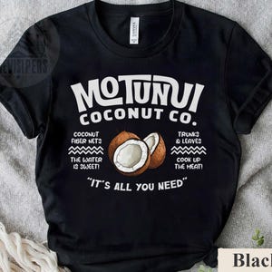 May include: Black t-shirt with the text "MOTUNUI COCONUT CO." and illustrations of coconuts. The shirt also features text about coconut fiber nets, water, trunks, leaves, and the phrase "IT'S ALL YOU NEED."