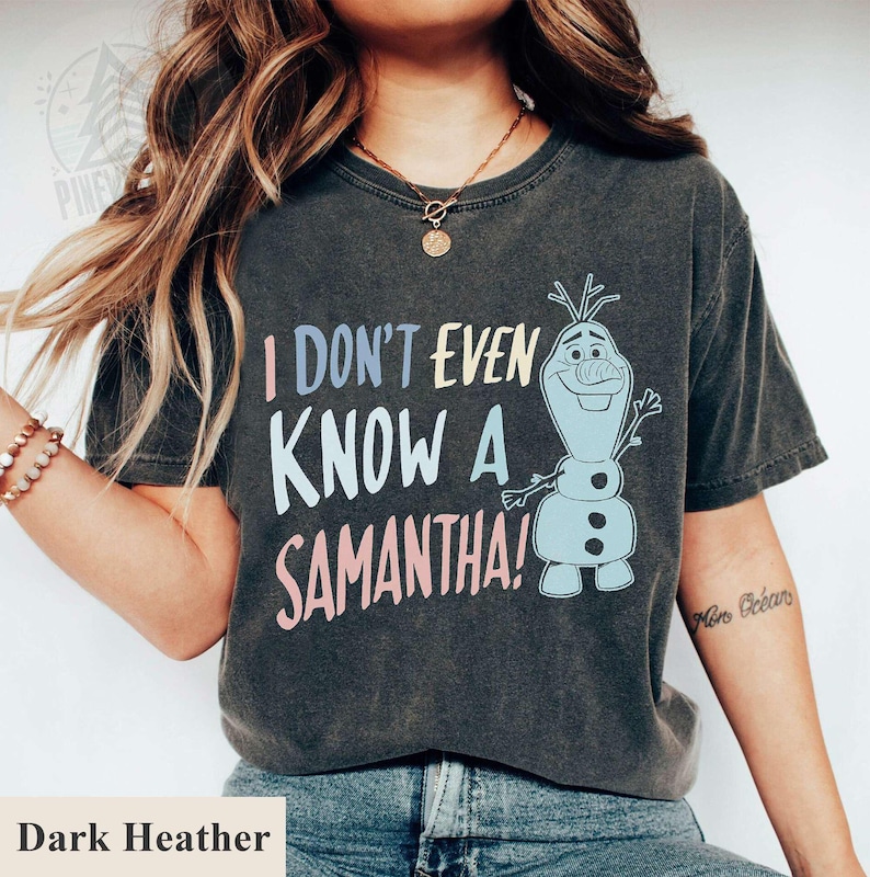 May include: Dark heather grey t-shirt with a graphic of Olaf from Frozen. The text on the shirt reads "I don't even know a Samantha!"