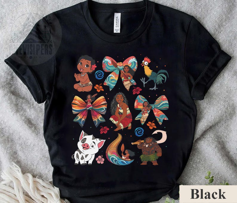May include: Black t-shirt featuring colorful illustrations of characters and bows. The design includes a baby, a rooster, a pig, and a man with a staff. The word "Black" is printed at the bottom right.