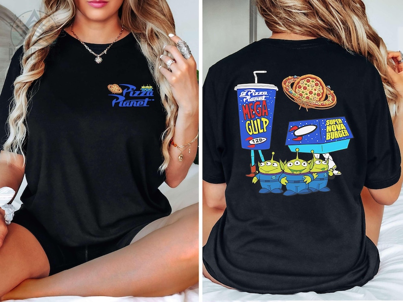 May include: Black t-shirt featuring the Pizza Planet logo on the front and a graphic of the Mega Gulp drink, pizza, Super Nova Burger, and the Little Green Men on the back. The shirt is a crew neck style.
