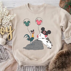 May include: A white ceramic mug with a black handle and the text "But First, Coffee" in a bold, black font. The mug is set against a blurred background, suggesting a cosy setting.