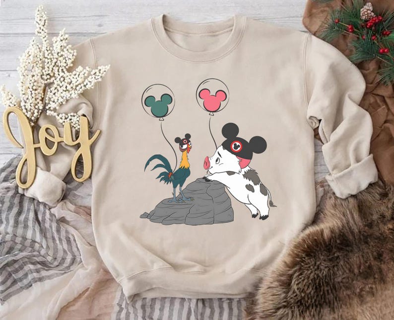 May include: A white ceramic mug with a black handle and the text "But First, Coffee" in a bold, black font. The mug is set against a blurred background, suggesting a cosy setting.