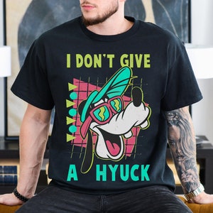 May include: Black t-shirt with a cartoon dog wearing sunglasses and a backwards hat. The text "I don't give a hyuck" is printed on the shirt.