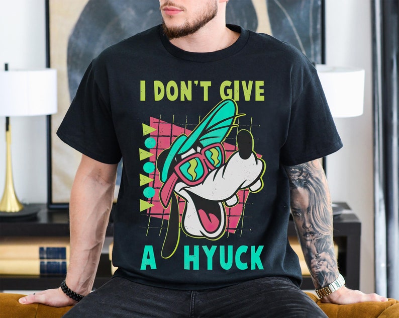 May include: Black t-shirt with a cartoon dog wearing sunglasses and a backwards hat. The text "I don't give a hyuck" is printed on the shirt.