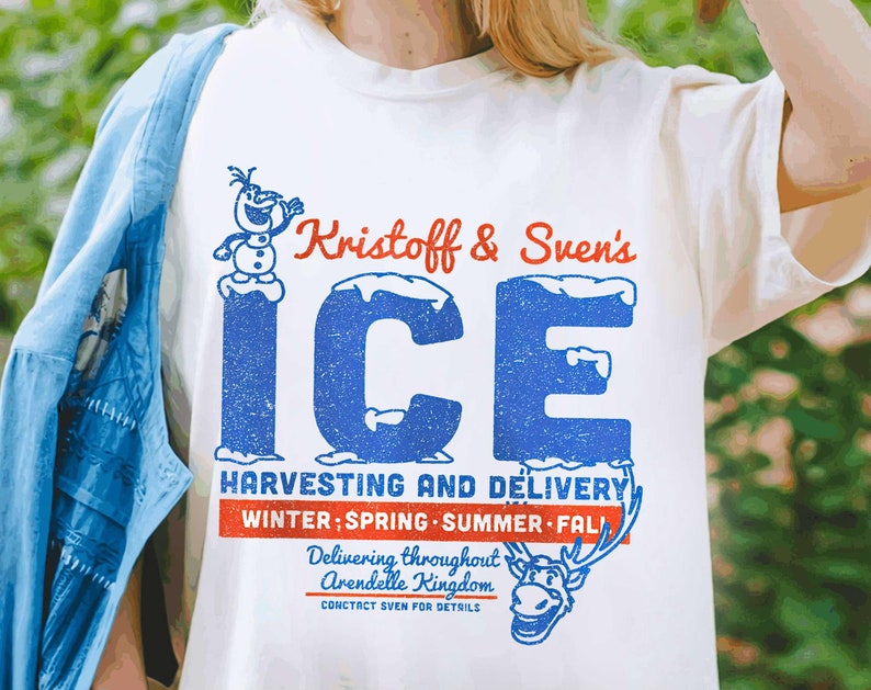 May include: White t-shirt with a blue and red graphic design featuring the text "Kristoff & Sven's ICE HARVESTING AND DELIVERY WINTER: SPRING SUMMER FALL Delivering throughout Arendelle Kingdom CONTACT SVEN FOR DETAILS". The graphic also includes a cartoon image of Olaf and Sven.