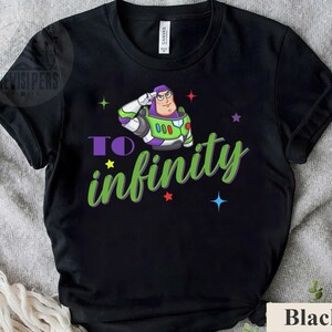 May include: Black t-shirt featuring a cartoon image of Buzz Lightyear saluting, with the words "TO infinity" in green and purple. The design includes colorful stars. The shirt is made of a soft material.