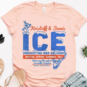 May include: A pink t-shirt with a vintage-style graphic featuring Kristoff and Sven's Ice Harvesting and Delivery service. The graphic includes a cartoon image of Olaf and Sven, and the text "Kristoff & Sven's ICE HARVESTING AND DELIVERY WINTER; SPRING SUMMER FALL Delivering throughout Arendelle Kingdom CONCTACT SVEN FOR DETAILS."