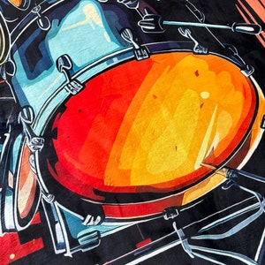 May include: A vibrant, abstract illustration of a drum set. The image features a large, red and orange drum with blue and black accents, and drumsticks. The artwork has a bold, graphic style, perfect for music lovers.
