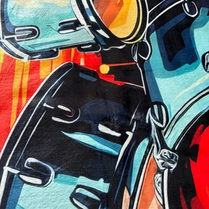 May include: Abstract art print featuring a close-up of a motorcycle. The artwork uses bold colors, including black, blue, red, and yellow. The design highlights the motorcycle's handlebars, mirrors, and body.