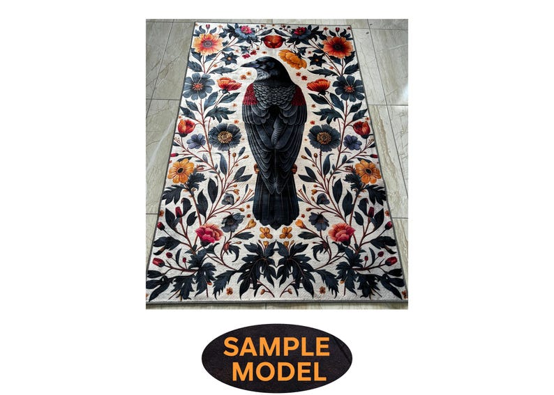 May include: A white rug with a black crow and floral design. The crow is in the center of the rug and is surrounded by flowers in shades of red, yellow, and orange.