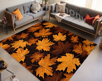 May include: A brown and gold area rug with a pattern of autumn leaves. The rug is laid out on a hardwood floor in a living room setting.