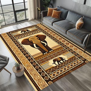 May include: A rectangular area rug with an elephant design. The rug features a central image of an elephant in shades of brown and beige, surrounded by geometric patterns and borders. The rug is placed in a living room setting.