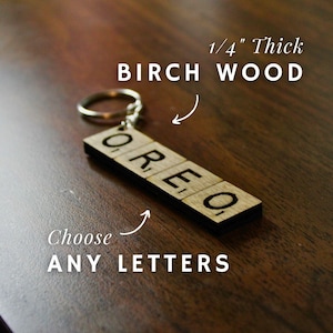 May include: A wooden keychain with the word "OREO" spelled out in individual tiles. The keychain is made from 1/4 inch thick birch wood and can be customized with any letters. Choose any letters.
