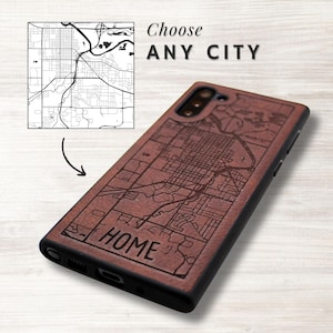 May include: A brown phone case with a city map design engraved on it. The case has the word "HOME" engraved on it. The text "Choose ANY CITY" is above a map graphic.