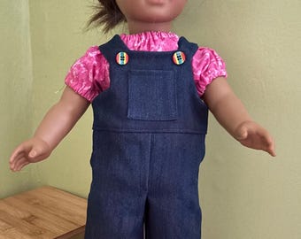 Short bibbed overalls with pink peasant top. Will fit 18' soft body dolls such as American Girl.