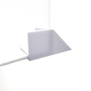 May include: White plastic corner shelf bracket with a right angle design.