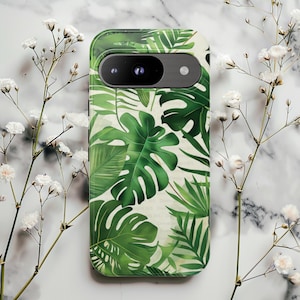 May include: A green and white phone case featuring a tropical leaf pattern. The case has a camera cutout and a smooth finish. The design includes large monstera leaves and other tropical foliage.